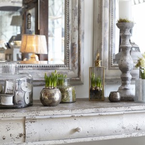 Botanicals on side table with large mirror above