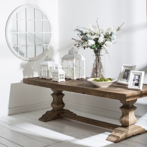 Pine table with lanterns flowers and pictures frames on top 