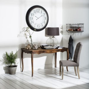 Elegant desk with large wall clock 