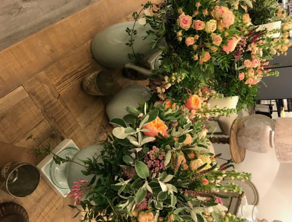 Pink and peach flowers in green vases