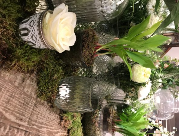 Flowers and foliage in glass vases