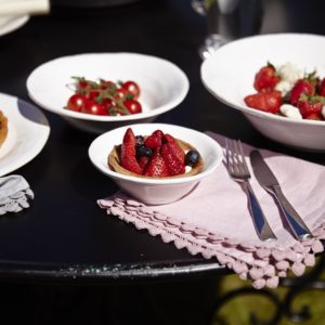 Strawberries and fresh fruit in white bowls