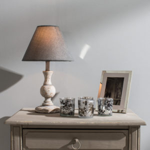 Side table with table lamp and votives