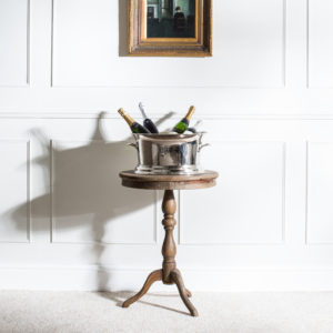 Wine cooler on small table with wine bottles