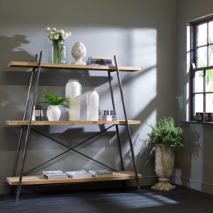 Open book shelf with green foliage and vases