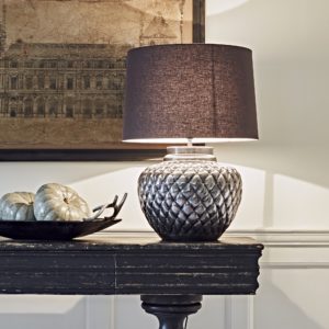 side table with pumpkins with table lamp