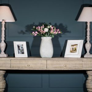 Pink faux flowers on sideboard 