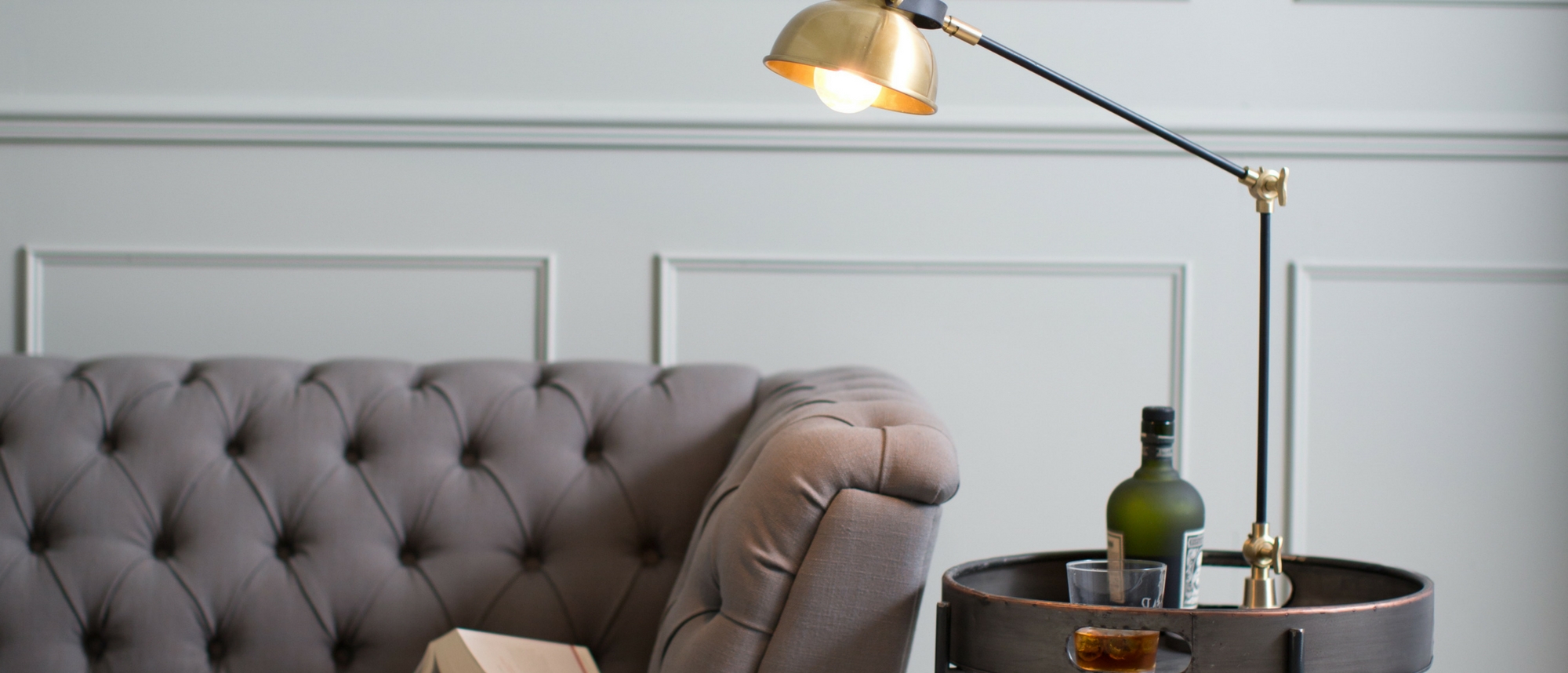 Grey sofa with table lamp and side table