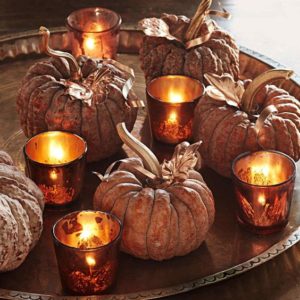 Round platter with decorative pumpkins and candles