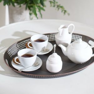 Tea pot and white china on tray