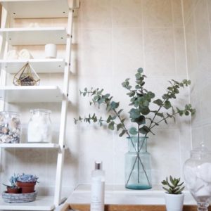 Bathroom shelving with eucalyptus in large vase