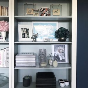 Bookshelves with picture frames and candles