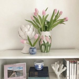 White shelving and pink tulips in vase