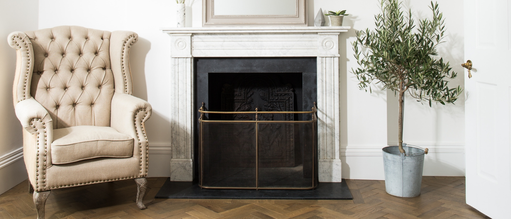 arm chair and fireplace with wooden floor