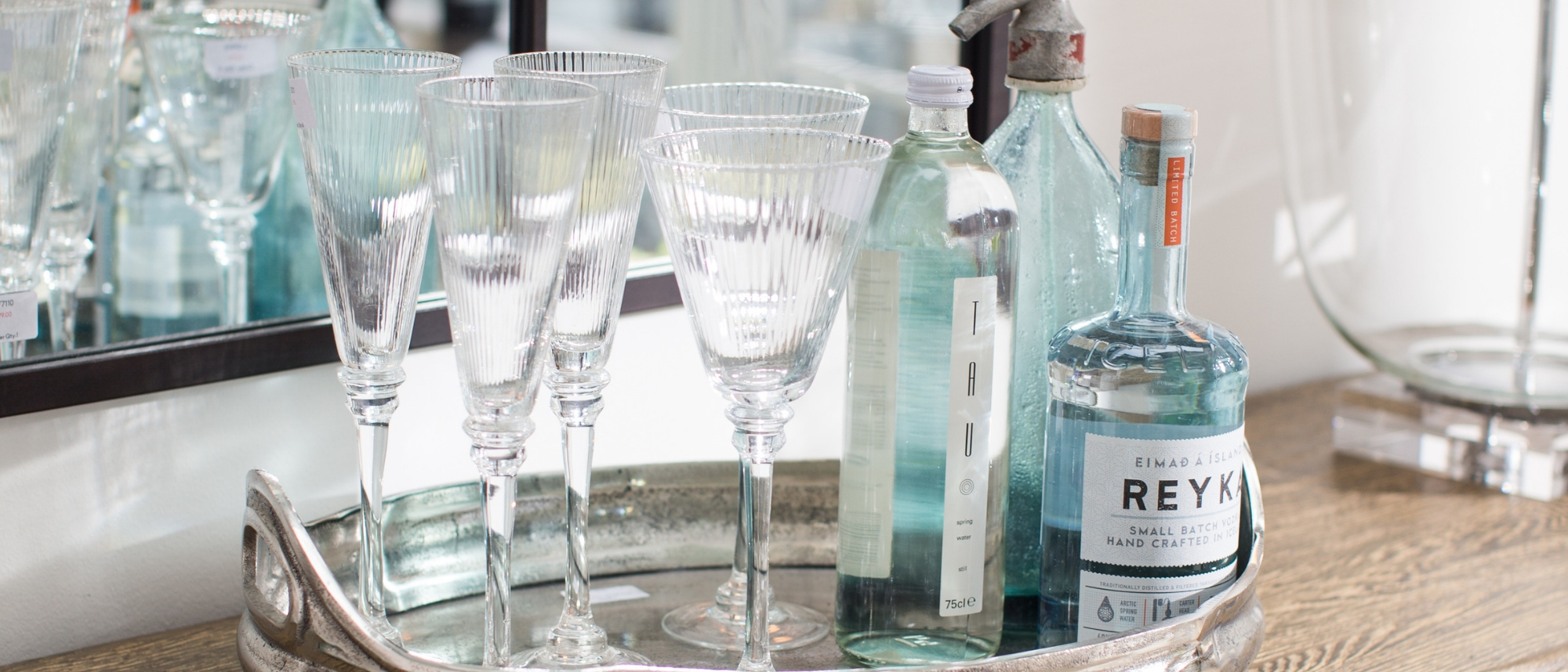 wine glasses and gin on a silver tray